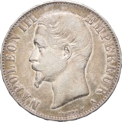Gros plan sur une pièce de monnaie portant le visage d'un homme
