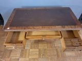 a wooden table with drawers underneath it on a hard wood floor