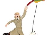 figurine représentant un homme faisant voler un cerf-volant avec un chien en laisse