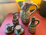 many different vases and cups on the table