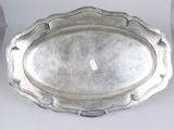 two silver trays sitting on top of a table next to each other