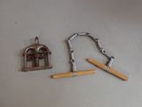 a small metal object with a wooden handle next to a small metal object with a wooden handle