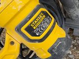 a yellow corded sander sitting on the ground next to a box