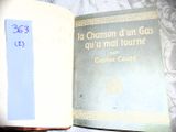 a book with a blue label on it sitting on a bed
