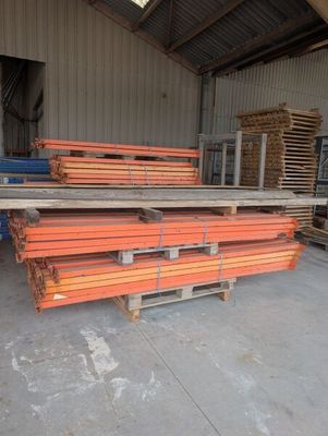 a pile of lumber in a warehouse next to a pallet