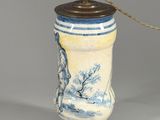 a blue and white lamp that is on a table