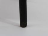 a close up of a black pipe on a white surface