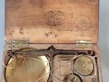 a wooden box with a brass plate inside of it