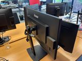 two computer monitors sitting on a desk in an office