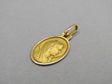 a close up of a gold medal with a woman ' s face on it