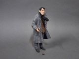 a figurine of a man wearing a coat and scarf