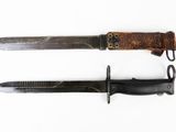 pair of old and rusty knifes on a white surface