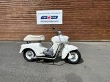 a scooter that is parked in front of a building