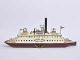 a small model of a boat on a white surface