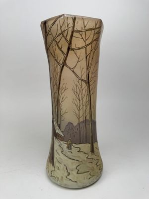 a vase that has a picture of trees on it