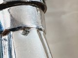 a close up of a metal pipe with a blue handle