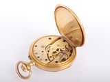 an image of a gold pocket watch on a white surface