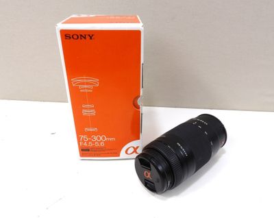 a close up of a camera lens sitting on a table next to a box
