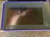an image of a purple tablet computer sitting on top of a table