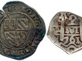 a silver coin with a cross on it and a shield on the front