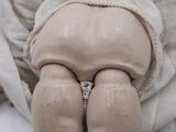 a doll that has a ring on it ' s butt