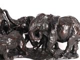 a statue of a group of elephants that are standing together