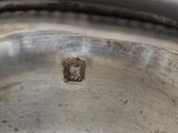 a close up of a metal bowl with a hole in it