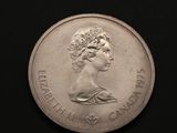 gros plan d'une pièce de monnaie sur laquelle figure un visage de femme