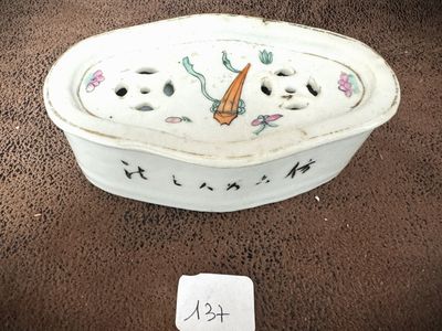 a white bowl with a carrot on it on a brown surface