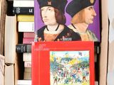 many books in a box that are sitting on a table
