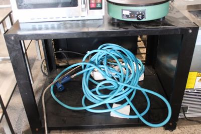 a microwave on a table with a bunch of wires on it