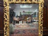 a mirror that is sitting on the floor in front of a wall