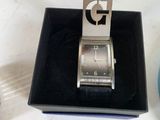 a person that is holding a watch in a box