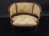 a chair with a floral upholstered back and a wooden frame