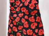 red and black floral print dress with green leaves on it