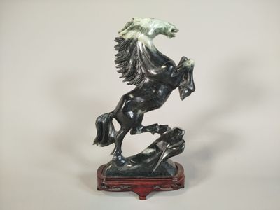 statue of a horse on a wooden base on a white background