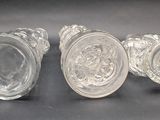 three clear glass knobs sitting on top of a black surface