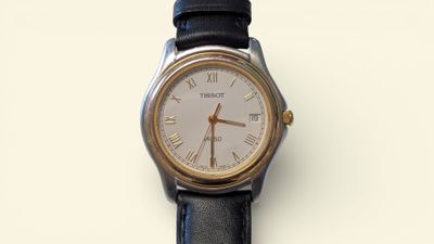 a silver and black watch with roman numerals on it