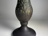 a vase that has a green and black design on it