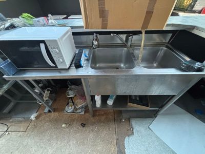 a kitchen with a sink and a microwave on the counter