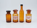 bottles of medicine are lined up in a row on a white surface