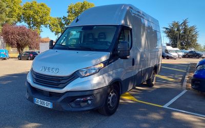 a silver van that is parked in a parking lot