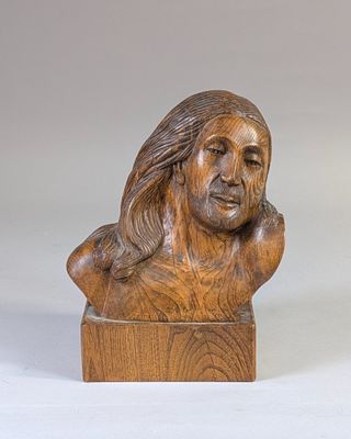 a wooden statue of a man with long hair