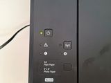 two black printers sitting on top of each other on a table
