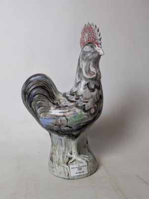 a ceramic rooster with a crown on it ' s head