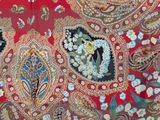 an image of a close up of a red and green paisley print fabric