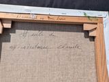 an old picture frame with writing on it sitting on a table