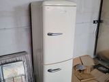 a white refrigerator next to a heater in a room