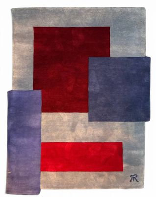 a red, blue and grey rug with squares on it
