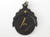 an image of a black and gold clock on a white surface